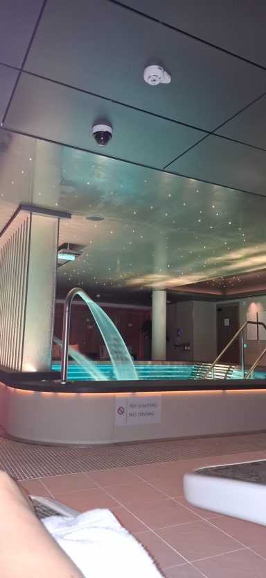 Indoor spa area with a water feature and ambient lighting.